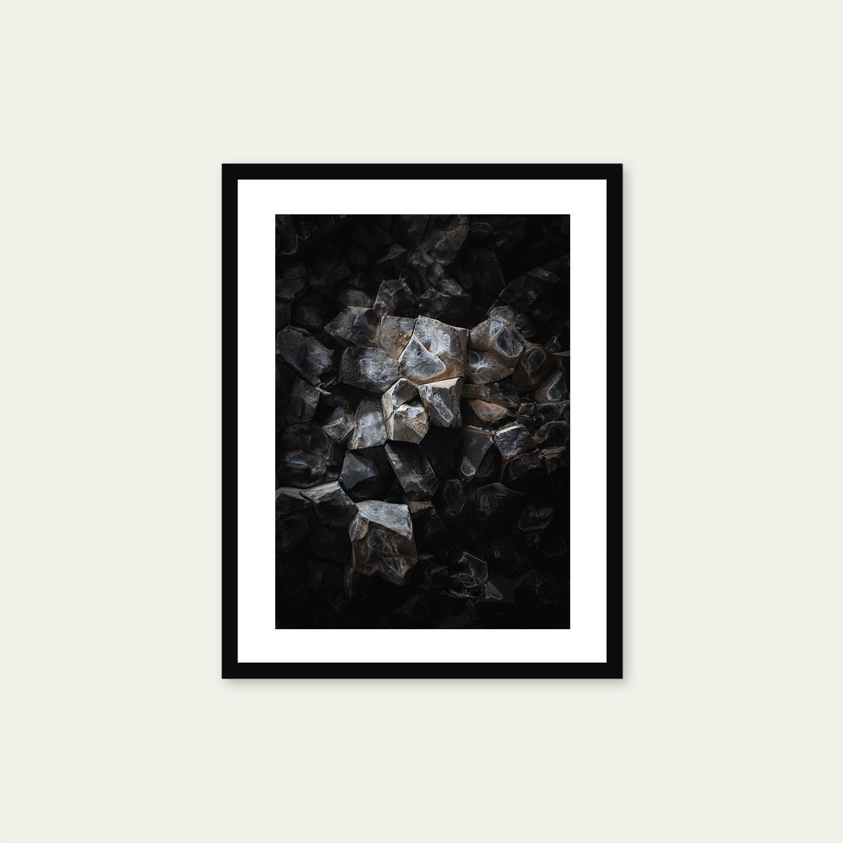 A black framed print of a detail from a basalt cave 