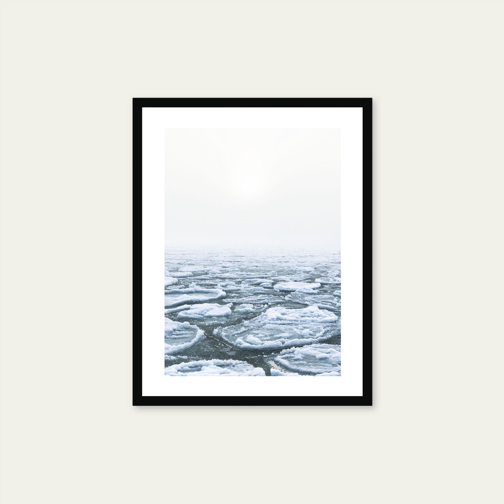 A black framed print of ice pans on foggy winter day
