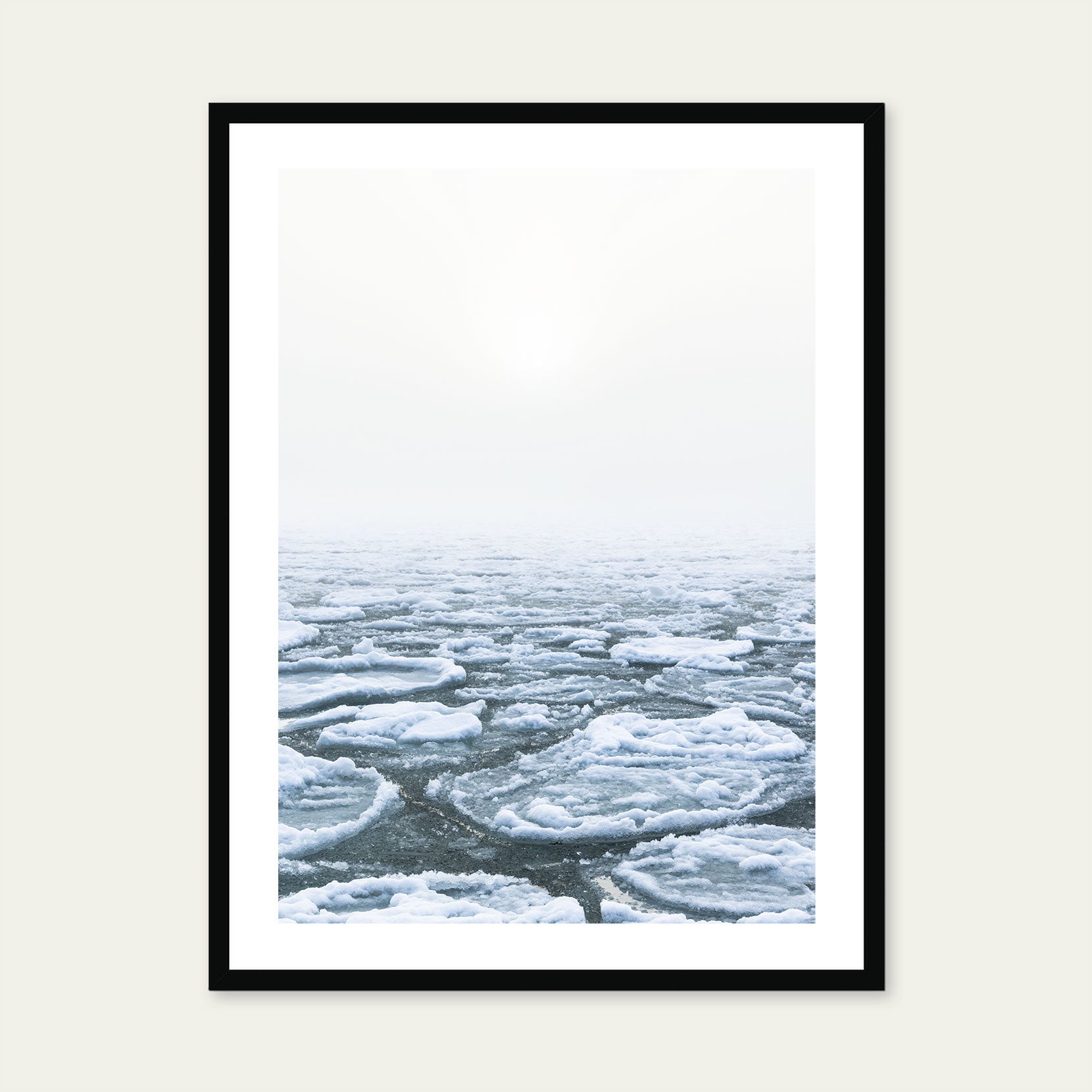 A black framed print of ice pans on foggy winter day