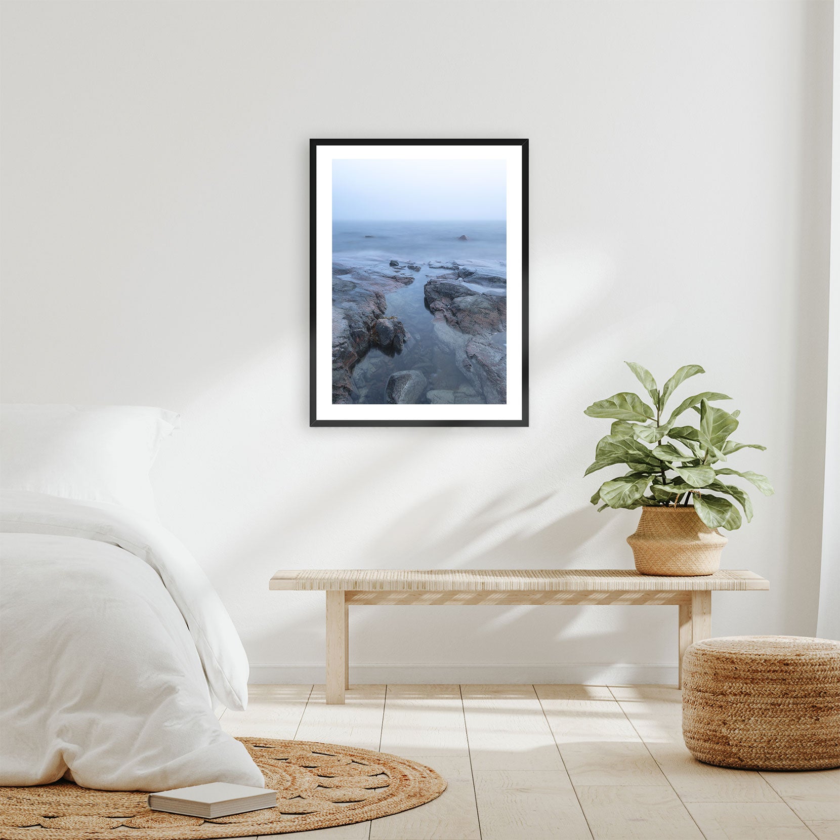 A framed print of a rocky coastline in fog