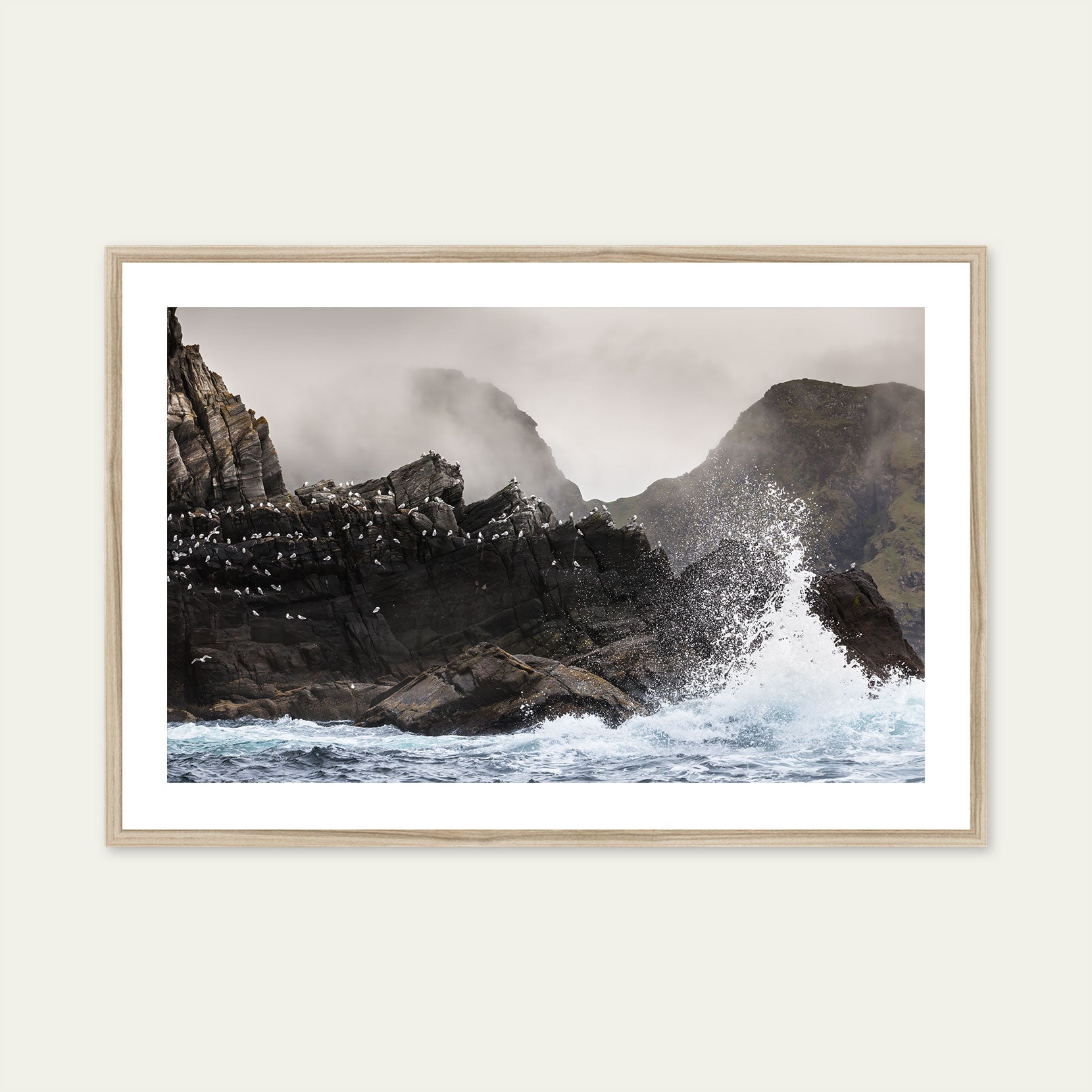 A wood framed print of a rough and rugged coast in Norway