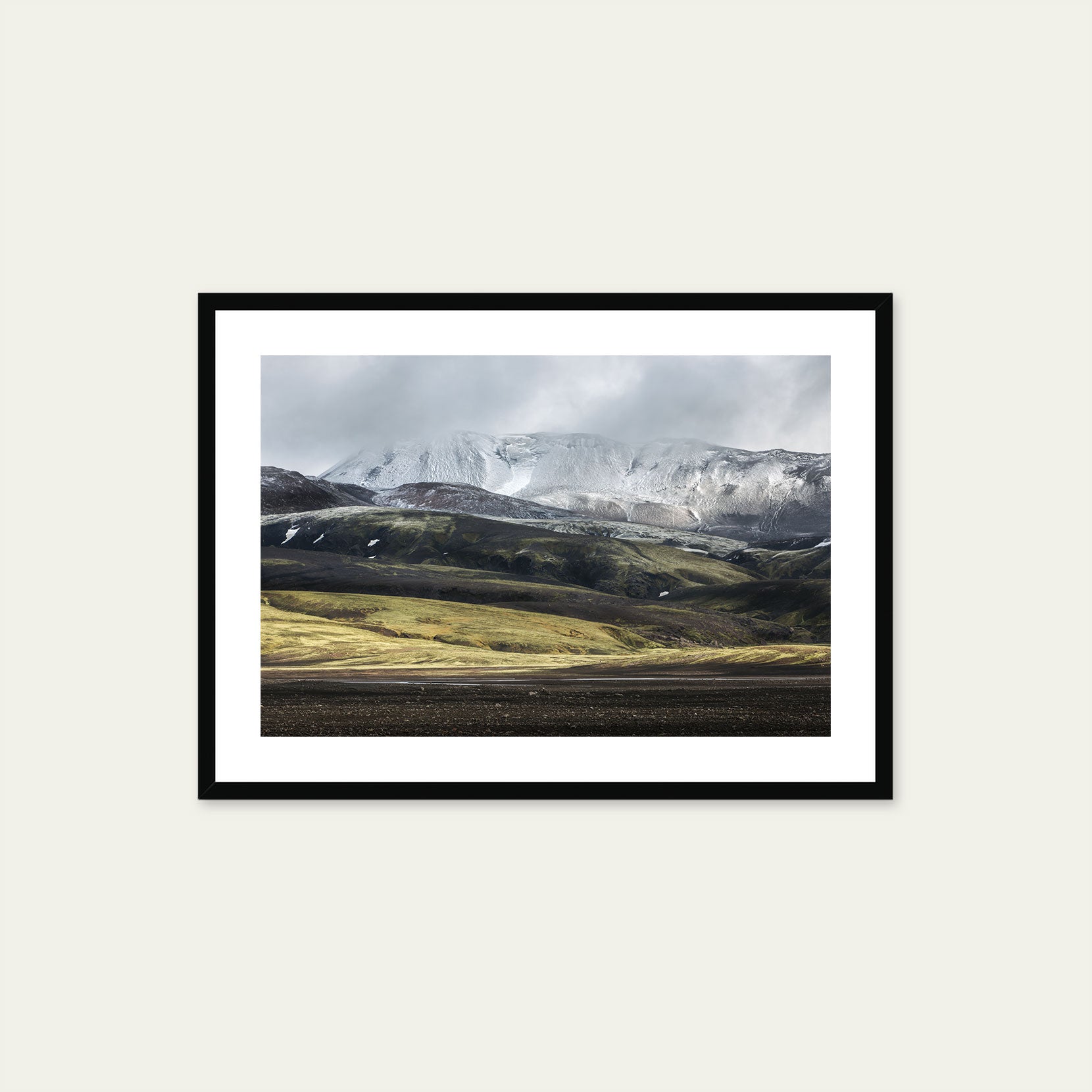 A black framed print of a mountain range in Iceland