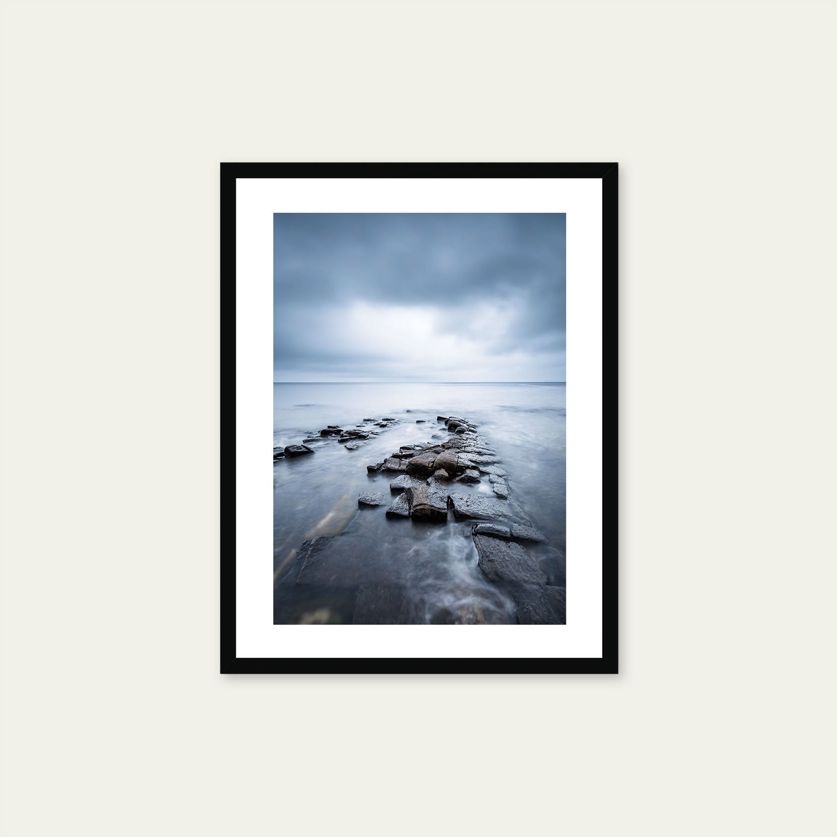 A black framed print of a moody seascape in Norway