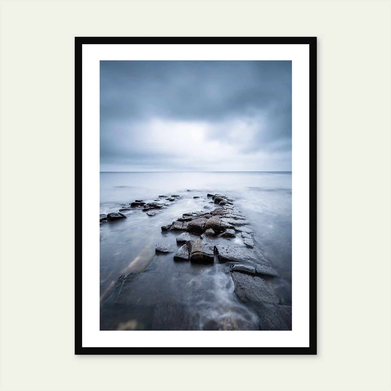 A black framed print of a moody seascape in Norway