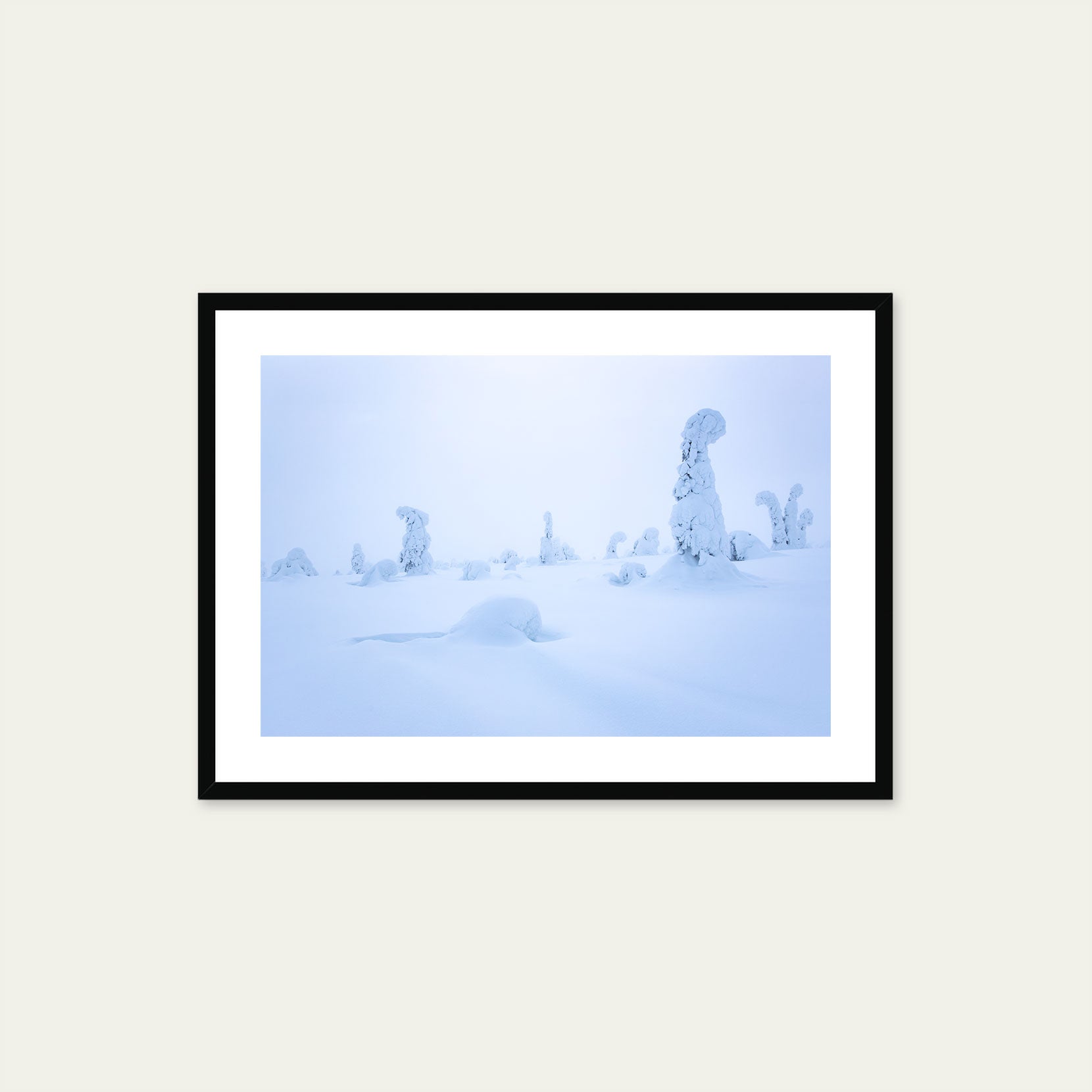 A black framed print of snow covered trees