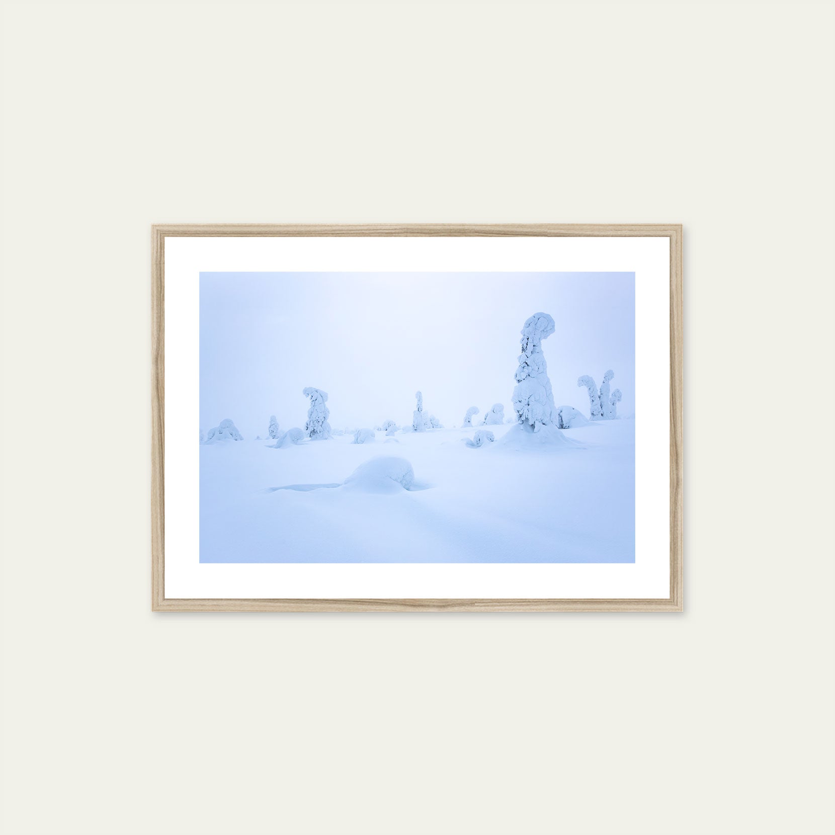 A wood framed print of snow covered trees