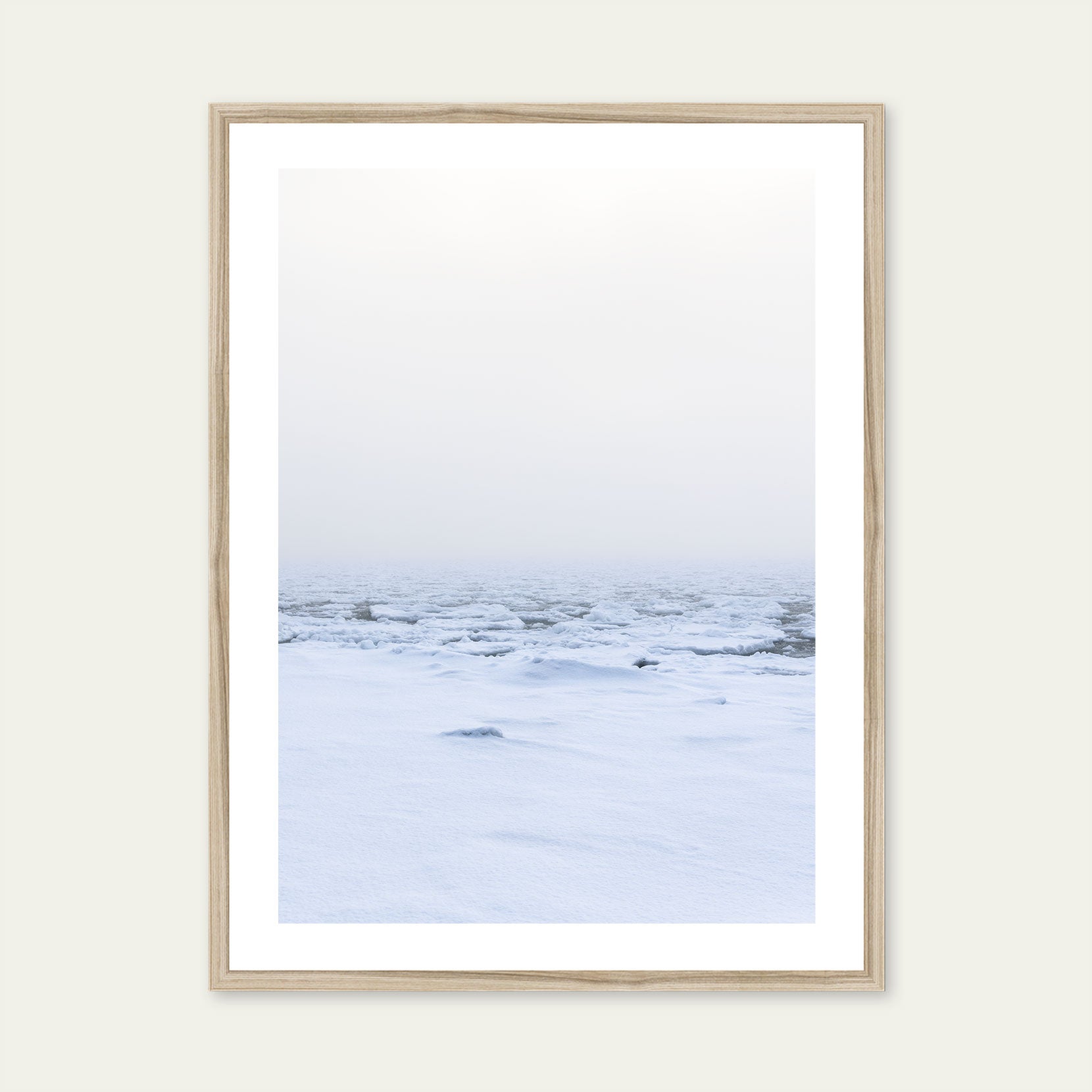 A wood framed print of a snow covered shoreline with fog