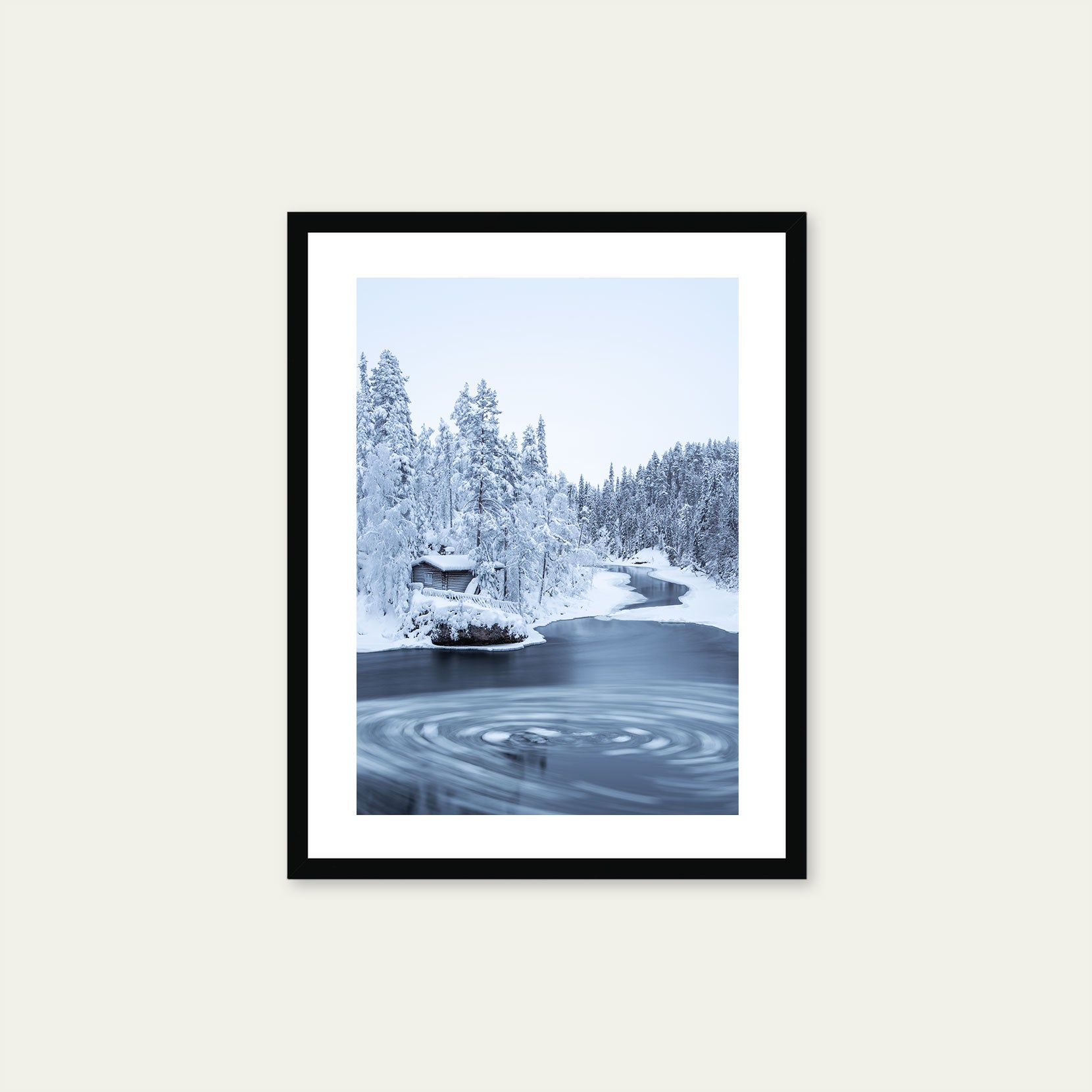 A black framed print of a wooden hut in winter forest