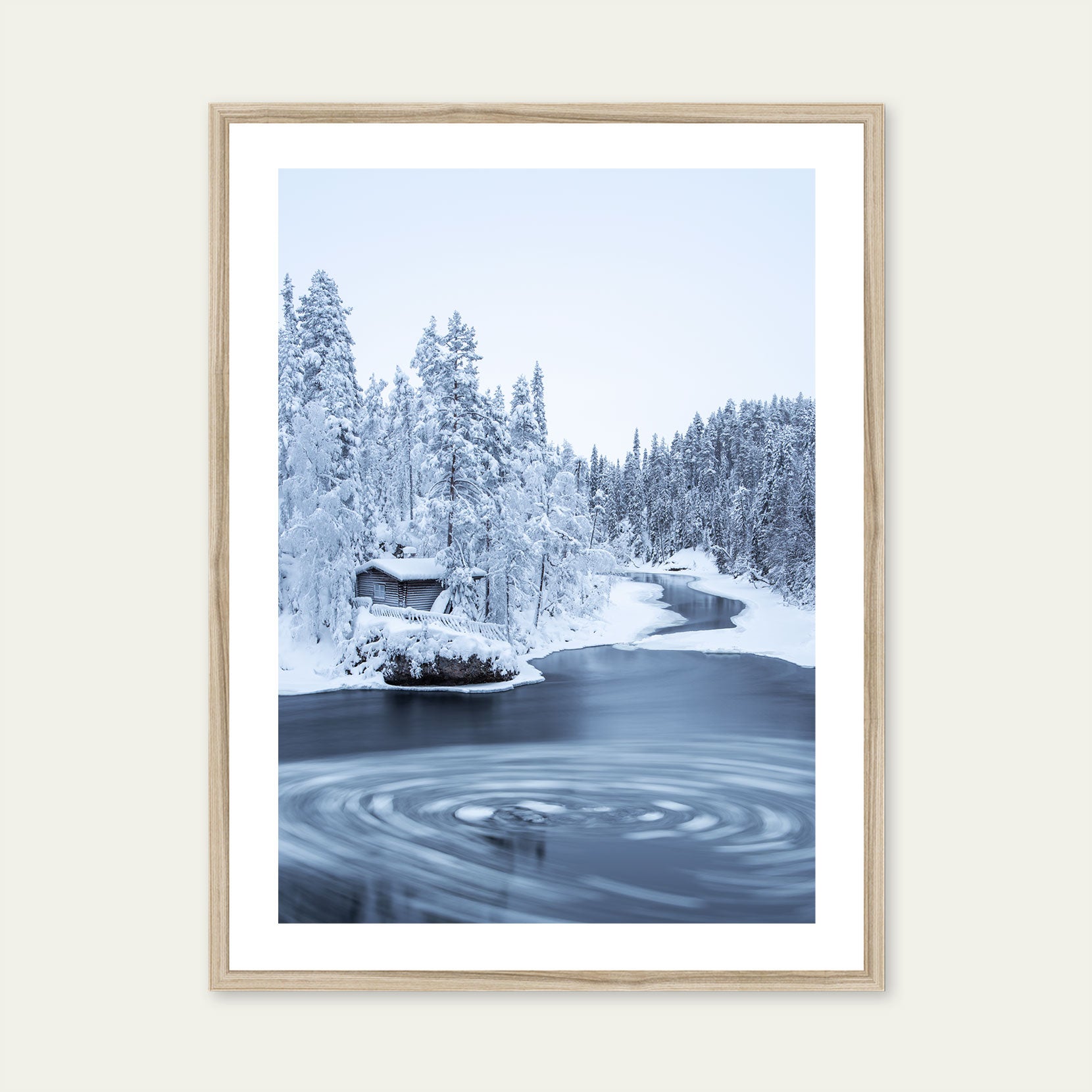 A wood framed print of a wooden hut in winter forest